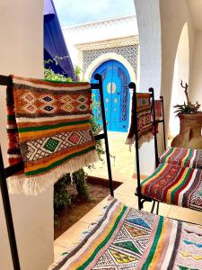 a room with two beds and a blue door at Dar Aladin in Arkou