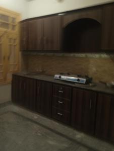 a kitchen with wooden cabinets and a counter top at Super luxury apartments in Mingora +18 photos