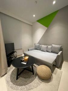 uma sala de estar com uma cama e uma mesa em Monde Residence K No 02 Batam Centre em Sengkuang