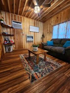 uma sala de estar com um sofá e uma mesa de centro em Unique Country Cabin Meets Farmhouse Modern!!! em Mena