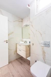蒂亞斯的住宿－VILLA PAPAYA，白色的浴室设有水槽和卫生间。