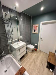 ein Badezimmer mit einer Badewanne, einem Waschbecken und einem WC in der Unterkunft Elegant Chic Living: 1 Bed In Vibrant London Area in London