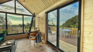 a large room with a deck with a table and chairs at Osada nad Zalewem in Tolkmicko