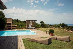 a swimming pool in a yard with a gazebo at Villa BARQUIERO in Coti-Chiavari