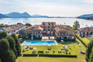 an aerial view of a mansion with a large swimming pool at Aquarama - By Impero House in Feriolo