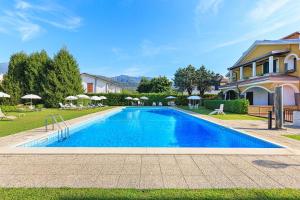 a swimming pool in a yard next to a house at Aquarama - By Impero House in Feriolo