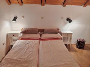 a large bed in a room with two desks at Apartments Kristic in Grabovac