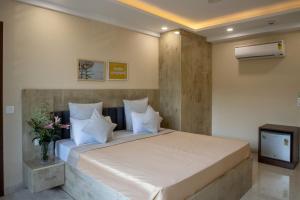 a bedroom with a large bed and a television at Perch Arbor Cyber City in Gurgaon +46 photos