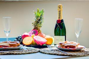 a bottle of wine sitting next to a table with fruit at Sea Paradise VIEW 115 in Playa Paraiso +24 photos