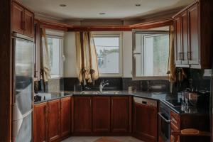 a kitchen with wooden cabinets and a sink at Ponte Suites in Antirrio