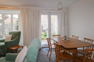 a living room with a dining room table and chairs at 83 Oaklands Road in Havant