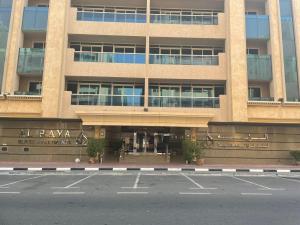 an empty parking lot in front of a building at Al Raya Hotel Apartments in Dubai