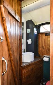 a bathroom with a tub and a sink on a train at The Big Yellow Bus in Montchevrier