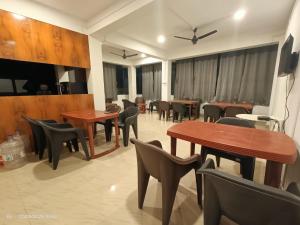 a dining room with tables and chairs in a restaurant at Manipur House in Imphal