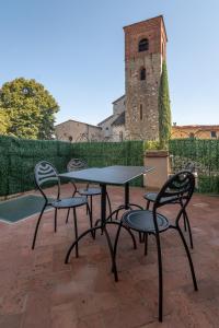 een tafel en vier stoelen op een patio bij Fabroniana Apartments in Pistoia