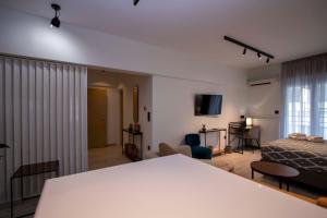 a bedroom with a bed and a living room at #ATS - Embassy Elegant Suite in Thessaloniki