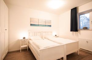 Postel nebo postele na pokoji v ubytování LM9-2-3 - Ferienwohnung Wremer Bogen Komfort