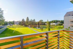 a balcony with a view of a park at Apartament SUN SurfingBird Dźwirzyno in Dźwirzyno