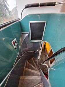 an escalator in a train with a window and stairs at The Big Yellow Bus in Montchevrier