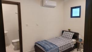 a small bedroom with a bed and a toilet at Villa Elena Hayat Island Marbella in Ras al Khaimah
