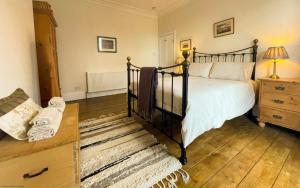 a bedroom with a bed and a dresser at Deerness, 4star gold award 2024, Whitby in Whitby