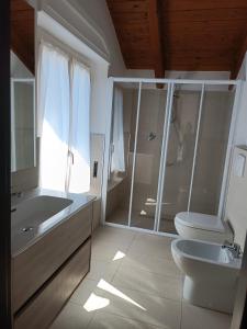 a bathroom with a shower and a toilet and a sink at Il Castagneto in Trivero
