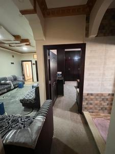 a living room with a couch and a room with a door at Petra luxurious view house in Wadi Musa