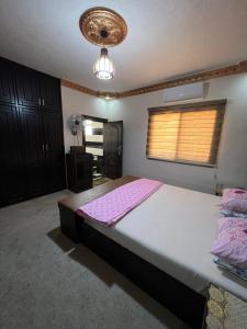 a bedroom with a large bed with pink sheets at Petra luxurious view house in Wadi Musa