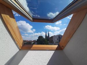 a window in a room with a view of a church at Gemütliche Wohnung in Burg in Burg bei Magdeburg +2 photos
