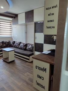 a living room with a couch and a table at PANORAMA SPA apartman in Kraljevo