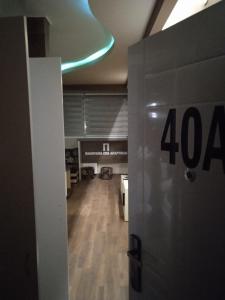 an open door to a room with a sign at PANORAMA SPA apartman in Kraljevo
