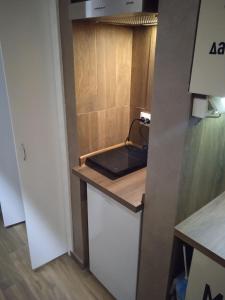a kitchen with a sink and a counter top at PANORAMA SPA apartman in Kraljevo