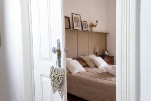um quarto com uma cama com almofadas brancas em Quinta José&Maria Quartos Ferreira do Zêzere em Ferreira do Zêzere