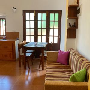 a living room with a couch and a table at Lihini cottage in Galle
