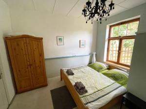 a bedroom with a bed and a window and a chandelier at KreativKate in Breetz