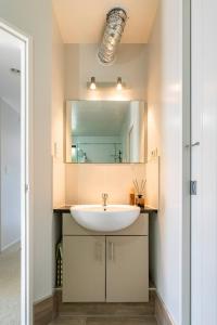 y baño con lavabo y espejo. en Private room in a lovely house, en Auckland