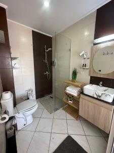 a bathroom with a shower and a toilet and a sink at FamilyConfort Saidia in Saïdia