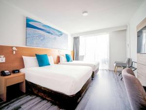 Postel nebo postele na pokoji v ubytování Novotel Cairns Oasis Resort