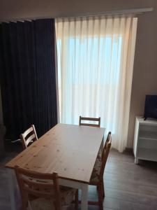 a wooden table and chairs in a room with a window at Il Castagneto in Trivero
