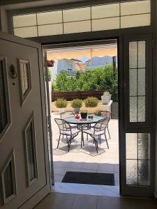 a patio with a table and chairs on a patio at John's house in Rhodes Town