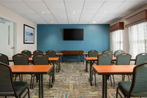 a conference room with tables and chairs and a tv at Hampton Inn & Suites Newport News-Airport - Oyster Point Area in Newport News
