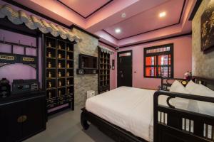 a bedroom with a bed and a wine cellar at DE Phanakron Boutique Hotel in Bangkok