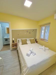 a bedroom with a large white bed with towels on it at Dimora Il Campanile in Chieti +25 photos