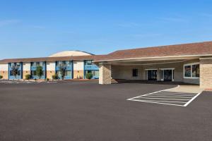 a building with a parking lot in front of it at AmericInn by Wyndham La Crosse Riverfront Conference Center in La Crosse
