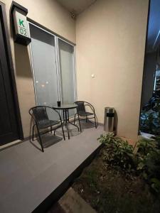 a patio with two chairs and a table on a building at Monde Residence K 01 Batam Centre in Nagoya