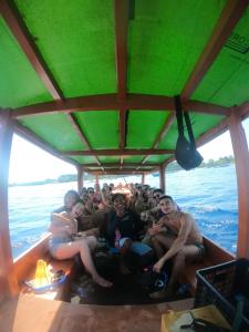a group of people sitting in the back of a boat at Gili Mesari Cottages & Homestay in Gili Trawangan