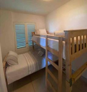 a bedroom with two bunk beds and a window at Unobstructed sea view gem (1 Spindrift) in St Francis Bay