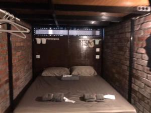 a small room with a bed in a brick wall at OA ThE FACTORY AT BUKIT BINTANG in Kuala Lumpur