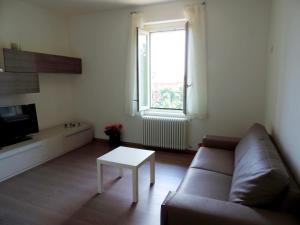 a living room with a couch and a table at Casa Maria in Bergamo