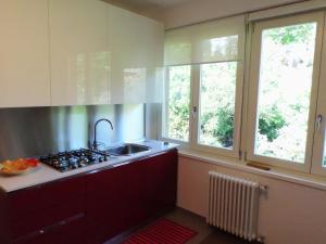 a kitchen with a sink and two windows at Casa Maria in Bergamo